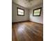 Bedroom with hardwood floors and two windows that provide plenty of natural light at 1130 Yeamans Hall Rd, Hanahan, SC 29410