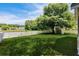Lush backyard with lake, storage shed, and white fence at 1136 Peninsula Cove Dr, Charleston, SC 29492