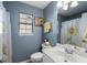 Well-lit bathroom with a single sink vanity, sunflower accents, and a shower-tub combination at 1136 Peninsula Cove Dr, Charleston, SC 29492