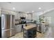Modern kitchen featuring stainless steel appliances, gray cabinetry, and a functional island, perfect for cooking at 1136 Peninsula Cove Dr, Charleston, SC 29492