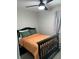 Neutral bedroom with a black bed, ceiling fan, neutral walls, and stylish curtains at 117 Fripp Ln, Summerville, SC 29483