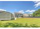 Expansive backyard featuring a pergola, fire pit, storage shed, and well-maintained lawn for outdoor enjoyment and relaxation at 122 Balsam Cir, Summerville, SC 29485