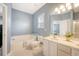 Bathroom featuring a white vanity, tub, toilet, and window at 122 Balsam Cir, Summerville, SC 29485