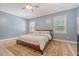 Comfortable bedroom with a ceiling fan, two windows, and light blue walls at 122 Balsam Cir, Summerville, SC 29485