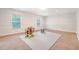 Spacious carpeted room with two windows, ideal for a playroom or bonus space at 122 Balsam Cir, Summerville, SC 29485