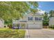 Charming two-story home with gray siding, blue shutters, an attached garage and a well-maintained lawn at 122 Balsam Cir, Summerville, SC 29485