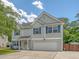 Charming two-story home featuring gray siding, blue shutters, an attached garage and a well-maintained lawn at 122 Balsam Cir, Summerville, SC 29485