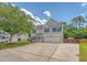 Charming two-story home featuring gray siding, blue shutters, an attached garage and a well-maintained lawn at 122 Balsam Cir, Summerville, SC 29485