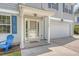 Inviting front entrance of home with gray siding, featuring blue chairs, storm door, and number 122 at 122 Balsam Cir, Summerville, SC 29485