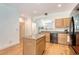 Kitchen features a center island, granite countertops, light wood cabinets, and stainless appliances at 122 Balsam Cir, Summerville, SC 29485