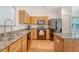 Kitchen features granite countertops, black appliances, hardwood floors, and light wood cabinets at 122 Balsam Cir, Summerville, SC 29485