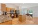 Bright kitchen with granite countertops, stainless appliances, and hardwood floors flows into a dining area at 122 Balsam Cir, Summerville, SC 29485