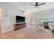 Living room with a sofa, TV, fireplace, carpet floors, and large window providing ample natural light at 122 Balsam Cir, Summerville, SC 29485