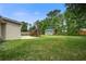 Backyard with shed, deck, well-maintained grass, and mature trees at 123 Wheeler Rd, Summerville, SC 29486