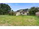 Spacious backyard with lush lawn, mature trees, and a fire pit at 123 Wheeler Rd, Summerville, SC 29486