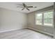 This bedroom features gray walls and floors, and a view to the backyard at 123 Wheeler Rd, Summerville, SC 29486