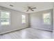 This bedroom features gray walls and floors, and a view of the front yard through the windows at 123 Wheeler Rd, Summerville, SC 29486