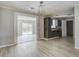 Dining area view featuring new flooring, modern chandelier, and kitchen view at 123 Wheeler Rd, Summerville, SC 29486