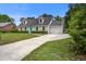 Brick home with dormer windows, attached garage and long driveway at 123 Wheeler Rd, Summerville, SC 29486