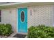 Charming brick home with a turquoise front door and decorative lighting at 123 Wheeler Rd, Summerville, SC 29486