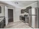 Functional kitchen with stainless steel refrigerator, light gray walls, and new flooring at 123 Wheeler Rd, Summerville, SC 29486