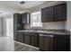 This kitchen features gray cabinets, stainless steel appliances, and a view to another room at 123 Wheeler Rd, Summerville, SC 29486