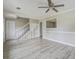 Large living room with modern flooring, built-in shelving, and staircase at 123 Wheeler Rd, Summerville, SC 29486