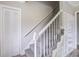 Carpeted staircase with white railing, closet, and a built-in bookshelf at 123 Wheeler Rd, Summerville, SC 29486