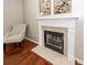 Living room fireplace with marble surround, a plush chair and hardwood floors at 139 Spindle Way, Goose Creek, SC 29445
