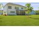 Expansive backyard features a screened porch perfect for outdoor relaxation and entertaining at 1411 Homecoming Blvd, Ravenel, SC 29470