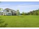 Spacious backyard with manicured lawn, screened porch, and ample room for recreation at 1411 Homecoming Blvd, Ravenel, SC 29470