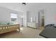 Bright bedroom features a wooden bed frame, natural light, and en-suite bathroom at 1411 Homecoming Blvd, Ravenel, SC 29470