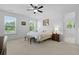 Bright bedroom with lots of windows and natural light, carpeted floor and ceiling fan at 1411 Homecoming Blvd, Ravenel, SC 29470