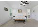 Spacious bedroom featuring a ceiling fan, carpeted floor, and connecting bathroom at 1411 Homecoming Blvd, Ravenel, SC 29470