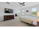 Comfortable bedroom featuring a ceiling fan, sitting area, and natural light at 1411 Homecoming Blvd, Ravenel, SC 29470
