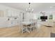 Dining room with modern light fixture, table with seating and connecting Living Room at 1411 Homecoming Blvd, Ravenel, SC 29470