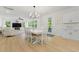 Bright dining area featuring a modern chandelier and white table with seating for six at 1411 Homecoming Blvd, Ravenel, SC 29470
