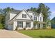 Traditional two-story home features well-maintained landscaping, adding to its charming curb appeal at 1411 Homecoming Blvd, Ravenel, SC 29470