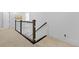 Hallway with dark wood and white railing, carpeted floor, and white walls at 1411 Homecoming Blvd, Ravenel, SC 29470