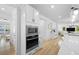 Modern kitchen featuring stainless steel microwave/oven combo and white cabinets with views of the living space at 1411 Homecoming Blvd, Ravenel, SC 29470
