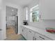 Modern kitchen with white cabinets, countertops, and stainless steel appliances at 1411 Homecoming Blvd, Ravenel, SC 29470
