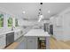 Modern kitchen featuring stainless steel appliances, white cabinets, and a large center island with seating at 1411 Homecoming Blvd, Ravenel, SC 29470