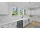 Bright kitchen featuring white cabinets, light countertops, stainless steel appliances and a view of the trees at 1411 Homecoming Blvd, Ravenel, SC 29470
