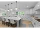 Bright, spacious kitchen featuring a large island with seating, modern appliances, and stylish pendant lighting at 1411 Homecoming Blvd, Ravenel, SC 29470