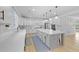 Bright, modern kitchen showcasing white quartz countertops, stainless appliances, and a spacious center island at 1411 Homecoming Blvd, Ravenel, SC 29470