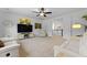 Spacious living room with neutral decor, a ceiling fan, and open access to the staircase at 1411 Homecoming Blvd, Ravenel, SC 29470