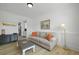 Cozy living room with comfortable seating, neutral decor, and open to the kitchen at 1411 Homecoming Blvd, Ravenel, SC 29470