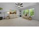 Well-lit living room with comfortable seating and a large window offering views of nature at 1411 Homecoming Blvd, Ravenel, SC 29470