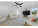 Spacious living room with a ceiling fan, fireplace, large screen television and seating at 1411 Homecoming Blvd, Ravenel, SC 29470