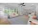 Comfortable living room features multiple seating areas, open floorplan and a ceiling fan at 1411 Homecoming Blvd, Ravenel, SC 29470